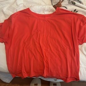 Lululemon coral colored cropped athletic t-shirt